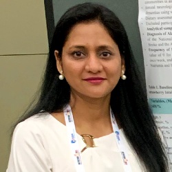 Dr. Puja Agarwal standing in front of an academic poster