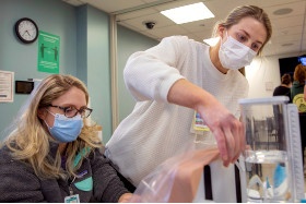 Two nursing students practicing respiratory procedure