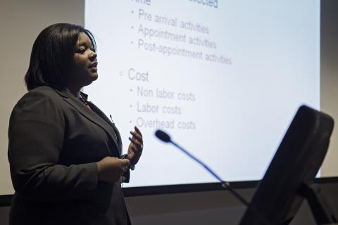 A Health Care Administrator delivers a presentation to her colleagues.