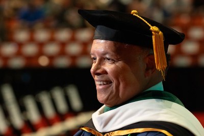 Close-up portrait of Robert S.D. Higgins, MD, MSHA, wearing academic regalia