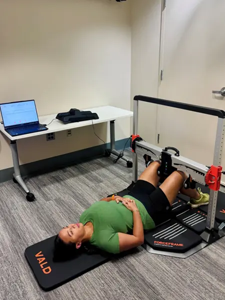 A person hooklying and being evaluated in the MARS Lab