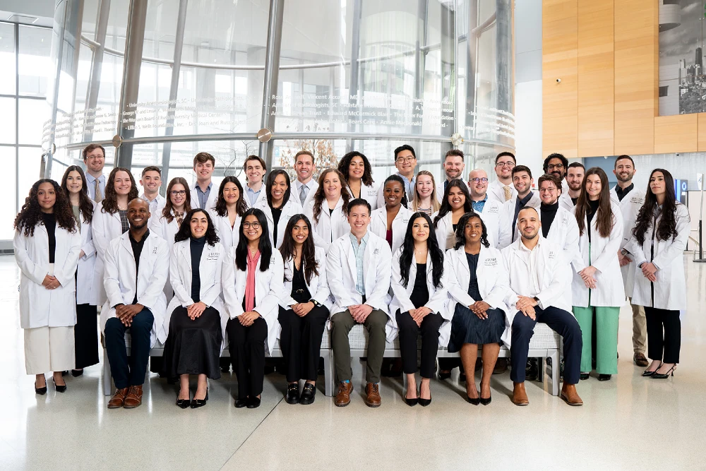 Group photo of EM residents in the Rush Atrium