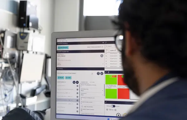 Arka Mallela, MD, MS, looks at a computer screen in the Rush Center for Brain Mapping
