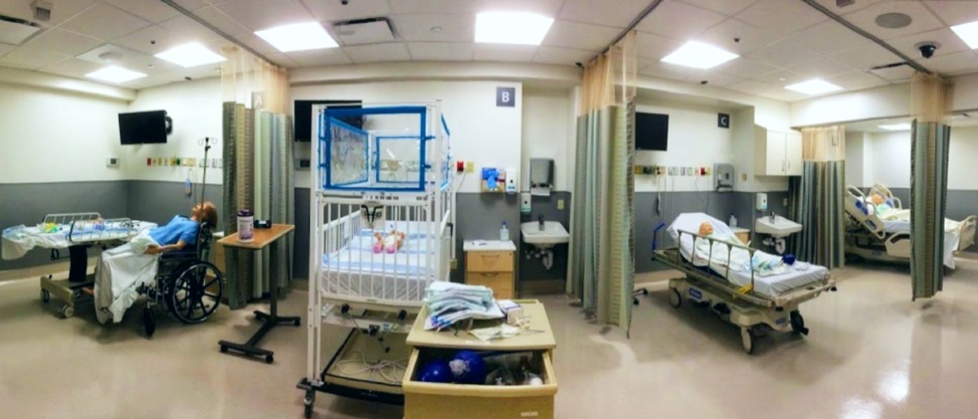 Panoramic view of a room with multiple patient areas