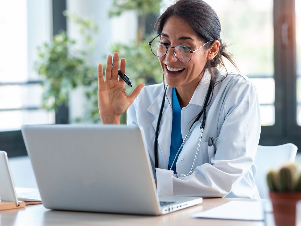 A telehealth provider uses a laptop for a visit
