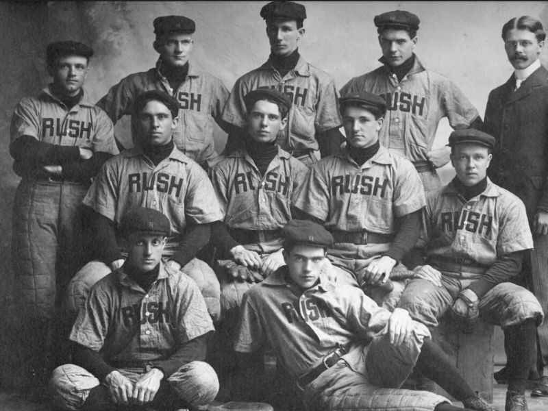 Black and white archival photo of a baseball team wearing Rush jerseys