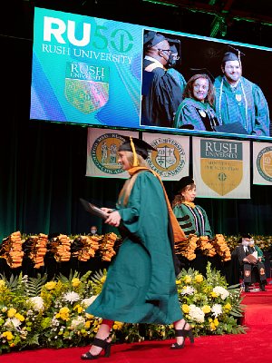 A graduate crosses the stage at Commencement