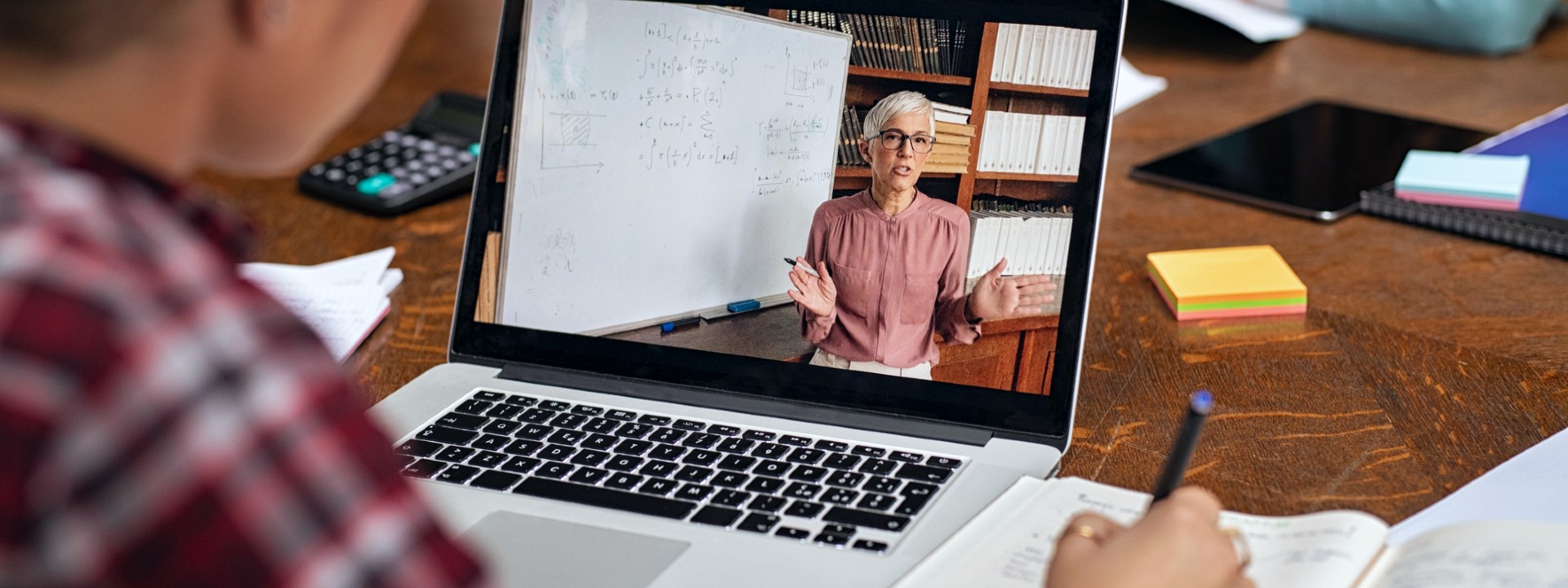 Laptop showing professor giving remote lecture