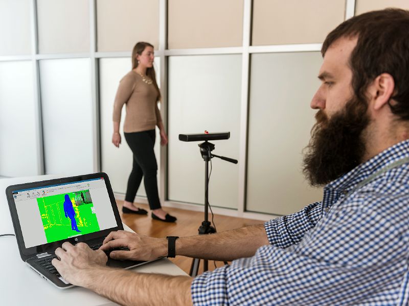 Researcher monitors a subject's gait on a laptop