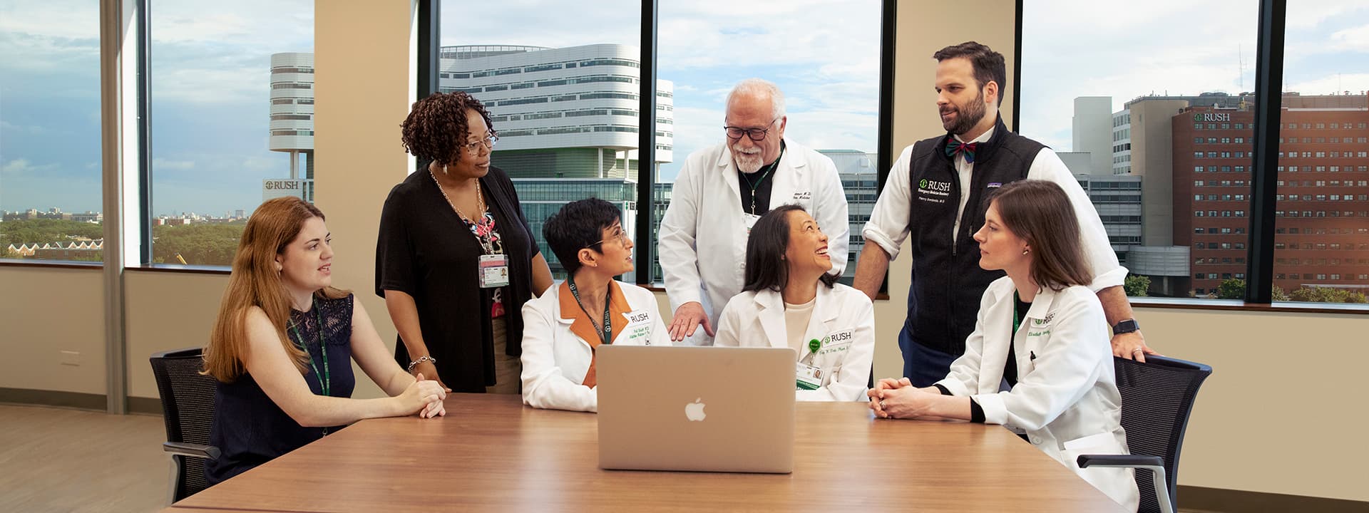 Team of physicians looking at a laptop
