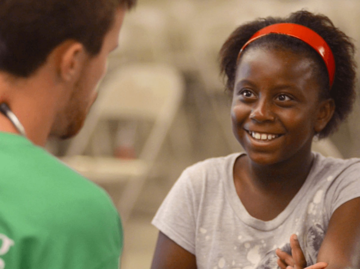 Doctor speaking to smiling child