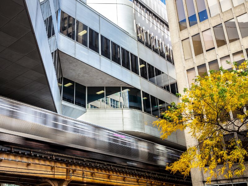 Elevated train tracks run between buildings on the Rush campus
