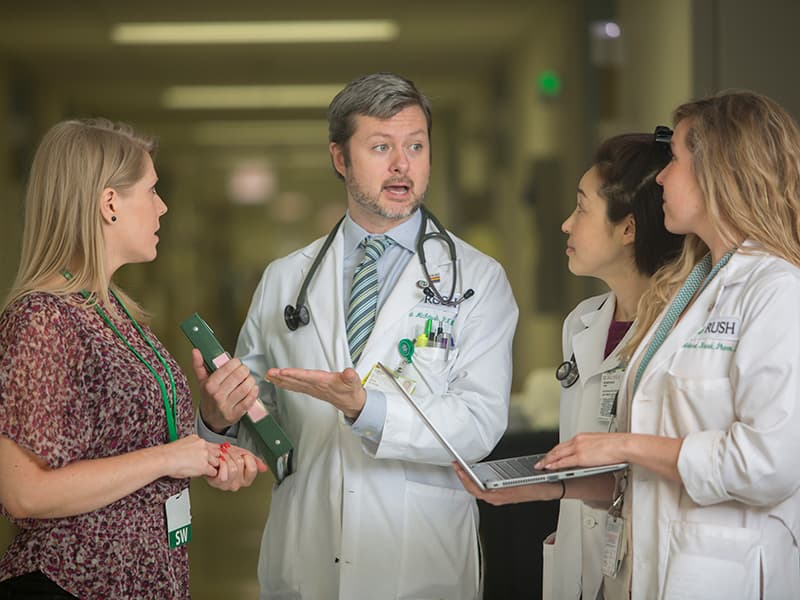 A Rush nurse practitioner meets with his colleagues 