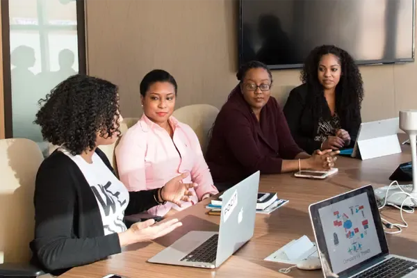 A group of people at a meeting sitting at a table