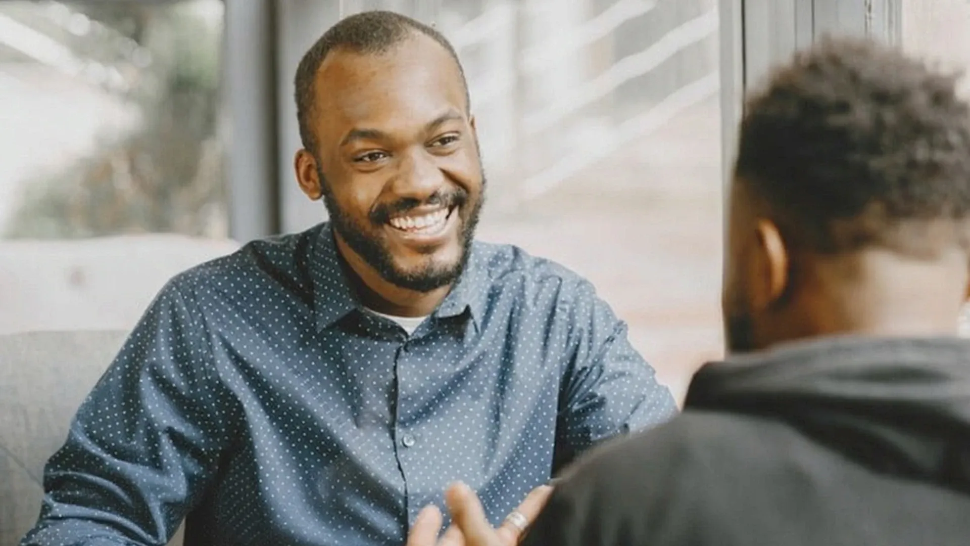 A Black man smiling.