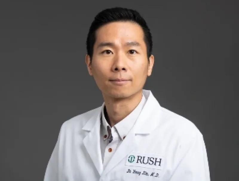 Headshot of Do Young Kim, MD, D(ABMM), wearing a white lab coat