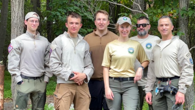 A group of six people standing together outdoors