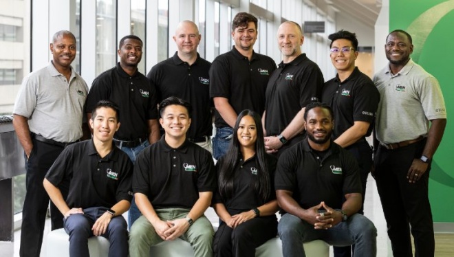 A group of students and faculty wearing shirts with the Men in Nursing logo