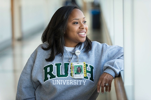 Student wearing a RUSH University sweatshirt looking out the window