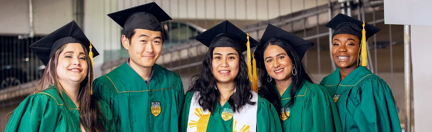 Five graduates wearing academic gowns and mortarboards