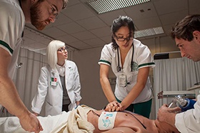 Nursing students practice chest compressions on a mannikin