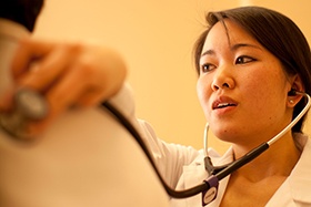 Health care provider using stethoscope