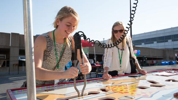 Students laugh as they enjoy a life-sized version of the board game Operation