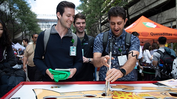 Students playing an oversized Operation game at a block party