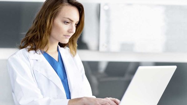 Health care provider using a laptop