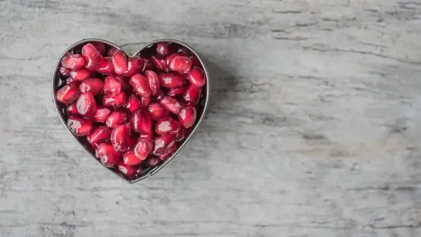 a heart filled with pomegranite seeds