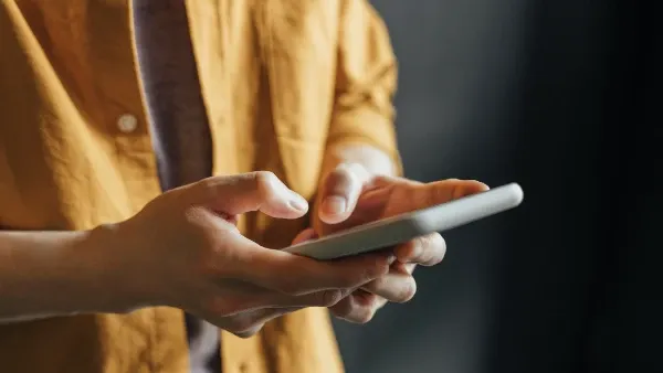 Close-up of a person's hands holding a phone