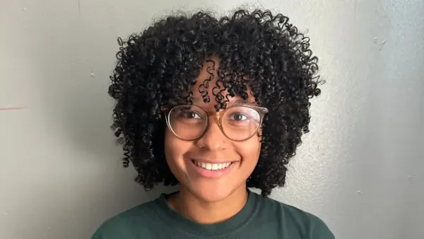 Head shot of a smiling woman wearing glasses