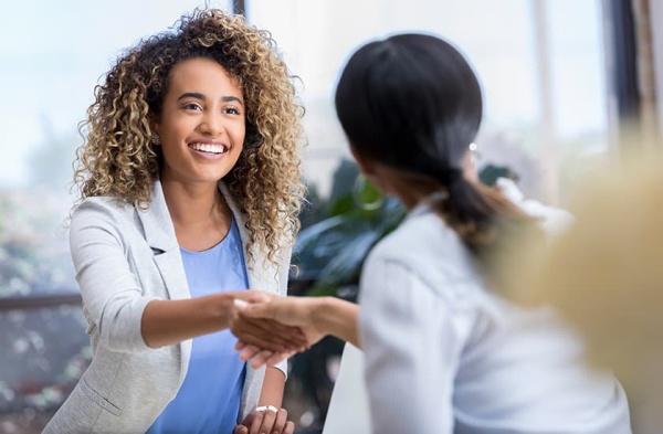 Ami Purohit, MD shaking hands with a colleague.