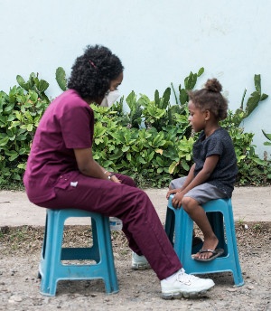 A doctor seated facing a young patient