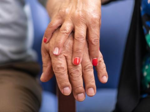 Close-up of two older adults' hands
