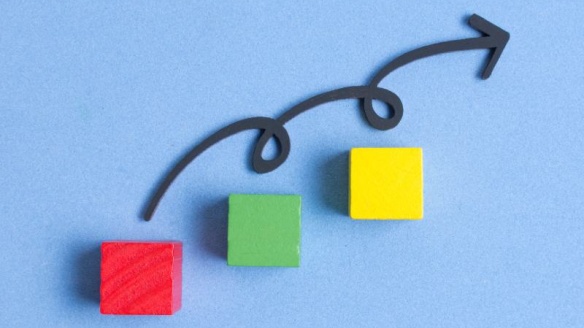 Three colored blocks arranged like steps, with an upward arrow