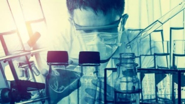 Biomedical researcher wearing eye protection