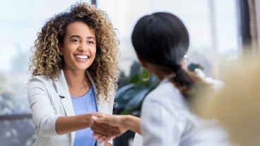 Two women shaking hands