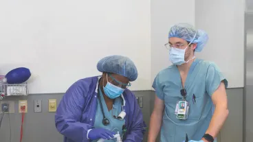Two Rush University College of Nursing students in scrubs