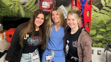 Rush Oak Park emergency medical staff (left to right) Emma Dziura, RN, Alexandra Pavalon, PCT, and Jenna Keating, RN, pose in front of a STB kit in the Emergency Department.  