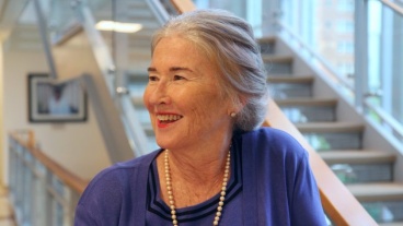 Christine Kennedy, seen smiling in profile in front of a flight of stairs