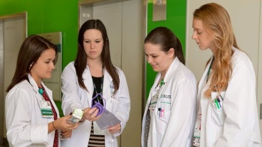 A group of nutritionists examine the label of a bottle