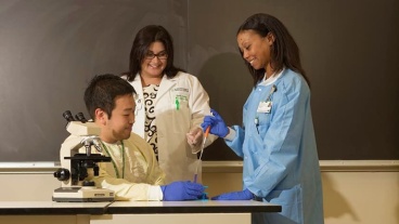 Students with microscope in a classroom