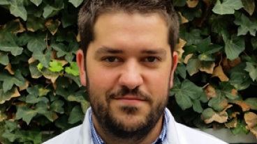 A man wearing a white coat