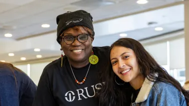 Two people looking at the camera and smiling