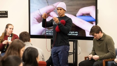 JP Arios teaches students how to crochet