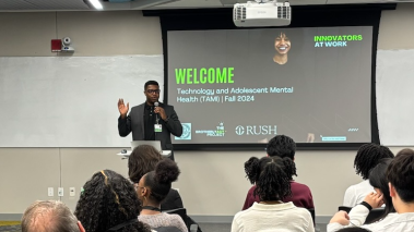 Chuka Emezue presents research to a crowd.