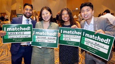 Four students smiling and holdig signs that say I Matched