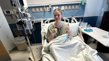 Madison Moore gives a thumbs up while in the hospital 