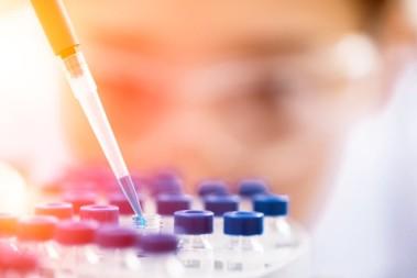 A researcher holding a pipette